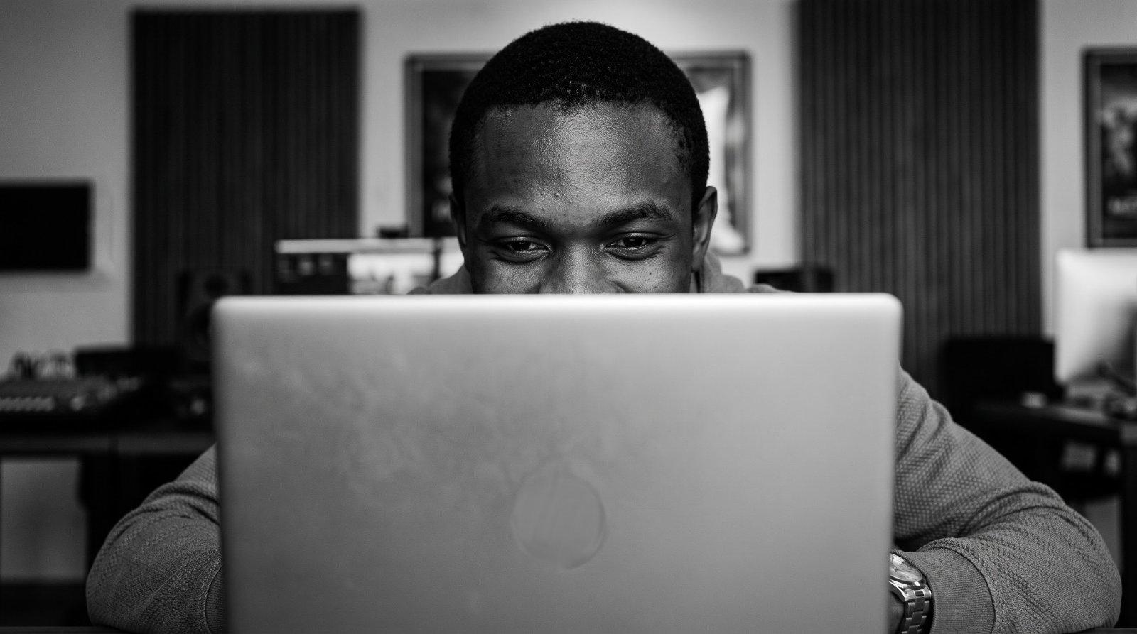 A young man looking ahead with quiet confidence after a breakthrough